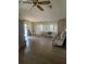 Living room featuring laminate floors, large windows, and a comfortable chair at 34315 Timberland Blvd, Wesley Chapel, FL 33543