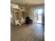 Comfortable living room area with laminate floors, sliding door, and a black recliner at 34315 Timberland Blvd, Wesley Chapel, FL 33543