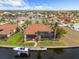 Waterfront home with a private dock, boat lift, screened lanai, and lush tropical landscaping, viewed from above at 3629 Licata Ct, Punta Gorda, FL 33950