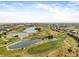 Panoramic aerial view of golf course community with lush greens, water features, and homes at 3629 Licata Ct, Punta Gorda, FL 33950