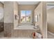 Bathroom featuring a garden tub with a window providing natural light and serene views at 3629 Licata Ct, Punta Gorda, FL 33950