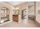 Open bathroom with tiled floors, double sink vanity, and relaxing garden tub at 3629 Licata Ct, Punta Gorda, FL 33950