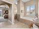 Bathroom featuring a garden tub with a window providing natural light and serene views at 3629 Licata Ct, Punta Gorda, FL 33950