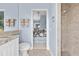 Bright bathroom with granite countertop vanity, shower, and view to the main bedroom at 3629 Licata Ct, Punta Gorda, FL 33950