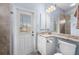 Bright bathroom with a granite countertop vanity, direct outdoor access, and tile floors at 3629 Licata Ct, Punta Gorda, FL 33950