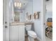 Bright bathroom with granite countertop vanity, light fixtures, and view to the main bedroom at 3629 Licata Ct, Punta Gorda, FL 33950