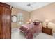 Well-lit bedroom with an arched window, ceiling fan, and traditional furnishings at 3629 Licata Ct, Punta Gorda, FL 33950