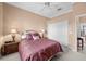 Comfortable bedroom with a ceiling fan, closet, and decorative bedside lamps at 3629 Licata Ct, Punta Gorda, FL 33950