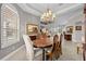 This dining room has a chandelier, a table with six chairs, two buffet tables and lots of natural light at 3629 Licata Ct, Punta Gorda, FL 33950
