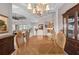 The dining room features a chandelier, a large table with six chairs, and a hutch for storage at 3629 Licata Ct, Punta Gorda, FL 33950