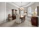 Formal dining room with chandelier, wood table and chairs, built in hutch, and lots of natural light at 3629 Licata Ct, Punta Gorda, FL 33950