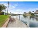 Private dock with channel views, seating, and a picturesque view of waterfront neighborhood on a sunny day at 3629 Licata Ct, Punta Gorda, FL 33950