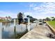 Dock with boat lift provides convenient waterfront access in this beautiful home, under a sunny blue sky at 3629 Licata Ct, Punta Gorda, FL 33950