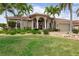 Charming home with lush landscaping, arched entrance, and a well-manicured lawn at 3629 Licata Ct, Punta Gorda, FL 33950