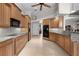 Well lit kitchen with granite countertops, wood cabinets and stainless steel appliances at 3629 Licata Ct, Punta Gorda, FL 33950
