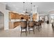 Spacious kitchen with wood cabinets, tiled floors, and island seating at 3629 Licata Ct, Punta Gorda, FL 33950