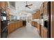 Spacious kitchen features stainless steel appliances, custom cabinets and island with granite countertops at 3629 Licata Ct, Punta Gorda, FL 33950