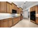 This kitchen features lots of wooden cabinets, granite countertops, tile floors, and stainless steel appliances at 3629 Licata Ct, Punta Gorda, FL 33950