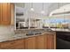 This kitchen has wooden cabinets, granite countertops, stainless steel appliances, and a large island sink at 3629 Licata Ct, Punta Gorda, FL 33950