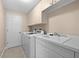 Well-organized laundry room with modern washer and dryer, sink, and plenty of storage at 3629 Licata Ct, Punta Gorda, FL 33950