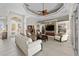 Elegant living room with custom ceiling, built-in shelving, stone fireplace, and bright natural light at 3629 Licata Ct, Punta Gorda, FL 33950