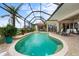 A screened-in lanai with a pool and spa surrounded by brick pavers leads to the home's interior and offers an outdoor oasis at 3629 Licata Ct, Punta Gorda, FL 33950