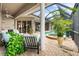 An inviting outdoor space features a pool, spa, brick pavers, comfortable seating, and views of the home's interior at 3629 Licata Ct, Punta Gorda, FL 33950