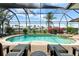 A screened-in lanai features a pool, spa, brick pavers, and waterfront views, perfect for relaxation and entertaining at 3629 Licata Ct, Punta Gorda, FL 33950