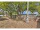 Private backyard with wood fence surrounded by mature shade trees at 3702 Pensdale Dr, New Port Richey, FL 34652