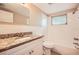 Bright bathroom with granite countertop, tiled shower and tub combination and a large mirror at 3702 Pensdale Dr, New Port Richey, FL 34652