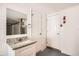 Well-lit bathroom with a granite sink, new cabinetry and mirror at 3702 Pensdale Dr, New Port Richey, FL 34652