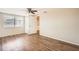 Neutral bedroom showcasing wood floors, closet space, and bright natural light at 3702 Pensdale Dr, New Port Richey, FL 34652