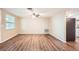 Cozy living room featuring wood floors, neutral walls, a ceiling fan, and natural light at 3702 Pensdale Dr, New Port Richey, FL 34652