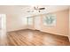 Inviting living room showcasing wood floors, a ceiling fan, neutral walls, and natural light at 3702 Pensdale Dr, New Port Richey, FL 34652