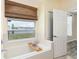 Bright bathroom with a soaking tub, a view of the yard, and natural light at 4174 70Th Street E Cir, Palmetto, FL 34221