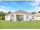 Exterior view of home showing screened lanai and well-maintained lawn under a bright blue sky at 4174 70Th Street E Cir, Palmetto, FL 34221