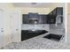 Modern kitchen featuring sleek black cabinets, stainless steel appliances, and a stylish backsplash at 4174 70Th Street E Cir, Palmetto, FL 34221