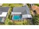 Aerial view of a single-Gathering home featuring a screened-in pool and lush green backyard at 23 Golfview Rd, Rotonda West, FL 33947