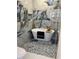 Bright bathroom with a modern white soaking tub, gold fixtures and striking blue and gold accent wall tiling at 23 Golfview Rd, Rotonda West, FL 33947