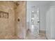 Modern bathroom featuring a tile shower with river rock floor and an open doorway at 23 Golfview Rd, Rotonda West, FL 33947