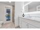 Stylish bathroom featuring vanity with modern lighting, basin, and walkout to the pool at 23 Golfview Rd, Rotonda West, FL 33947