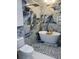 Luxurious bathroom featuring a soaking tub, rainfall shower, and stylish blue and gold marble-look tile at 23 Golfview Rd, Rotonda West, FL 33947