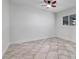 Bedroom featuring neutral tile floors, a ceiling fan, and a window for natural light at 23 Golfview Rd, Rotonda West, FL 33947