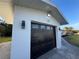 Attached single car garage with black automatic door at 23 Golfview Rd, Rotonda West, FL 33947