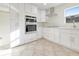 Modern kitchen with stainless steel appliances, white cabinets, and bright natural light at 23 Golfview Rd, Rotonda West, FL 33947