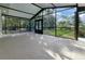 Spacious screened-in patio overlooking lush landscaping, perfect for outdoor relaxation and entertainment at 23 Golfview Rd, Rotonda West, FL 33947