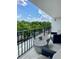 Balcony featuring outdoor seating with views of lush trees for relaxing and enjoying the outdoors at 3211 W Swann Ave # 408, Tampa, FL 33609