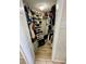 Walk-in closet featuring built-in shelving and organized storage for clothing and shoes at 3211 W Swann Ave # 408, Tampa, FL 33609