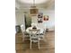Bright dining area featuring a white table with four chairs, a unique chandelier and three abstract art pieces at 3211 W Swann Ave # 408, Tampa, FL 33609