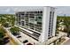 Stunning aerial view of a modern condo building with a well-maintained parking area and beautiful landscaping at 3211 W Swann Ave # 408, Tampa, FL 33609